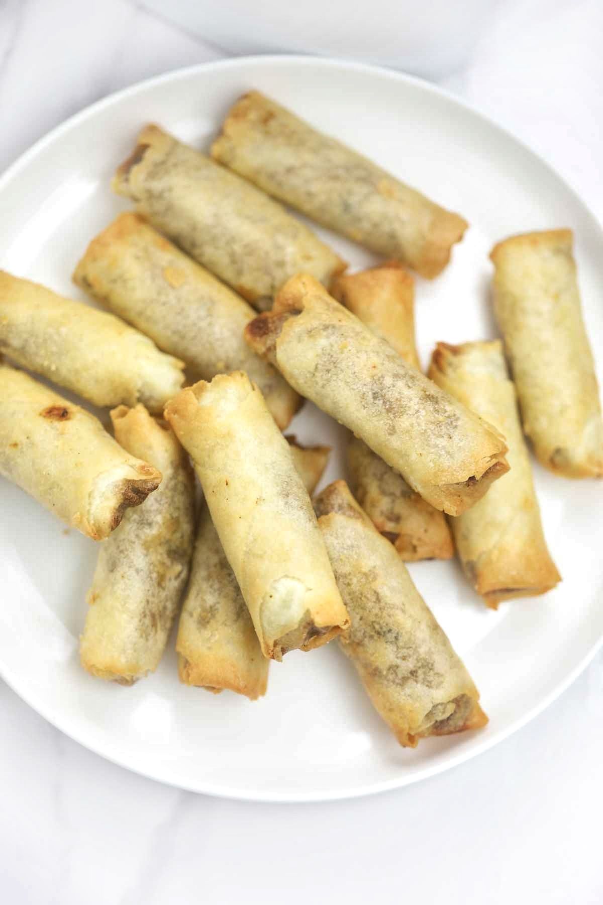 reheated spring rolls served on a plate.