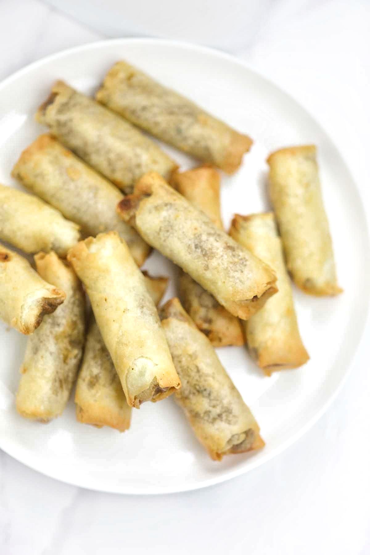 Spring rolls on a white plate.